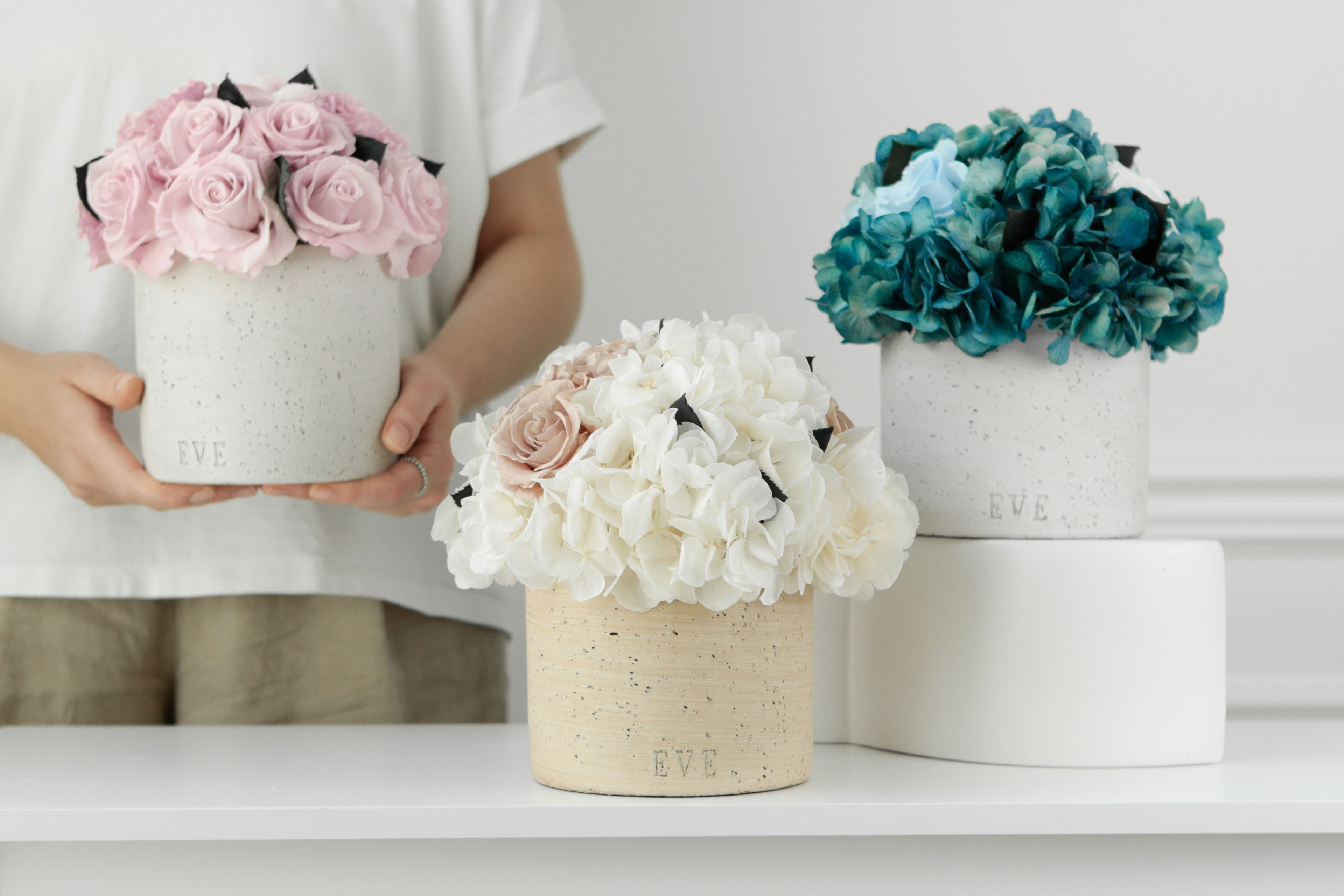 Elevate Your Space with Evergreen Roses' Timeless Floral Arrangements in Concrete Vases